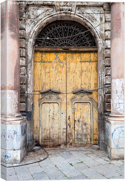 What is behind the yellow door ? Canvas Print by Dave Carroll