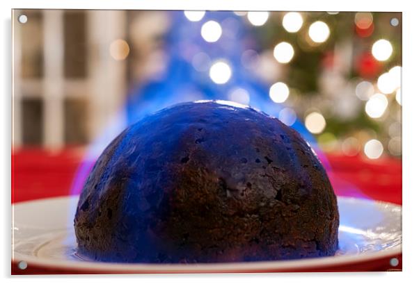 Christmas Pudding on a table, with a Christmas tre Acrylic by Dave Carroll