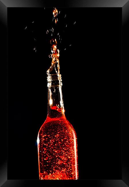Exploding Wine Bottle Framed Print by Eddie Howland
