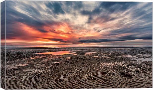 Low tide at sunset Canvas Print by Guido Parmiggiani