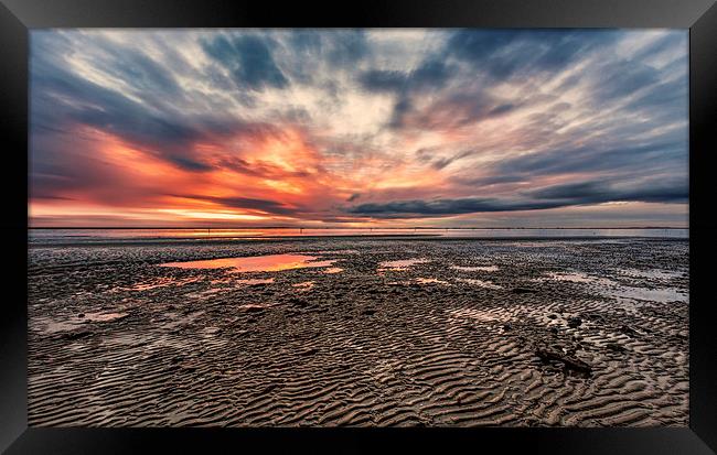 Low tide at sunset Framed Print by Guido Parmiggiani