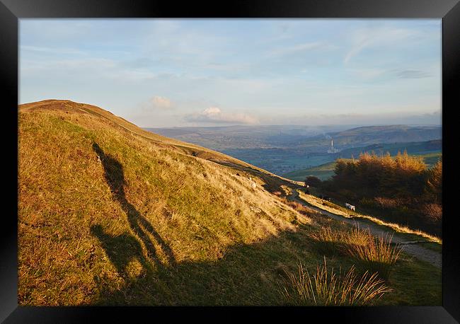 Shadow of a male and his dog on mounatinside at su Framed Print by Liam Grant