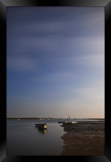 Moonlight on boats under a star filled sky. Branca Framed Print by Liam Grant