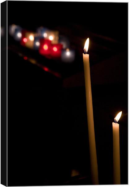 Candles burning in Eglise Saint Pierre d'Arène. Canvas Print by Ian Middleton