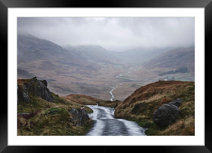 Rain clouds and road through the Wrynose Pass. Cum Framed Mounted Print by Liam Grant