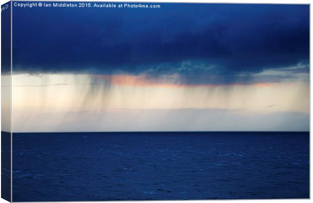 Rain on the horizon at Strumble Head Canvas Print by Ian Middleton