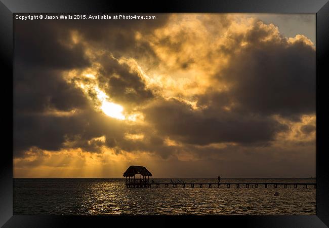 Rays of sun above a jetty Framed Print by Jason Wells