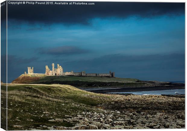 Dunstanburgh Castle in Northumberland  Canvas Print by Philip Pound