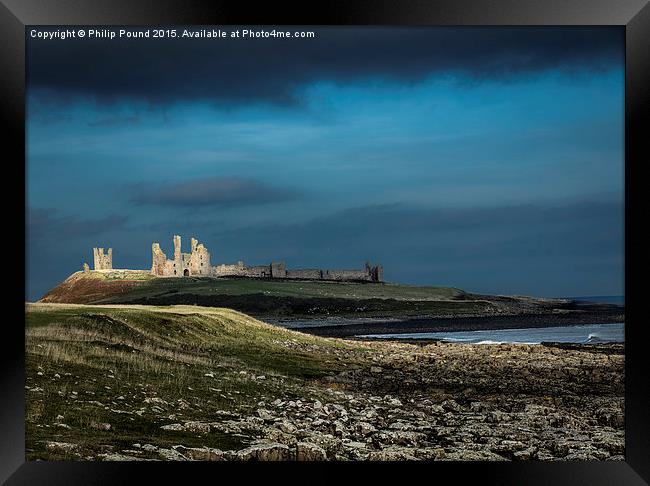 Dunstanburgh Castle in Northumberland  Framed Print by Philip Pound