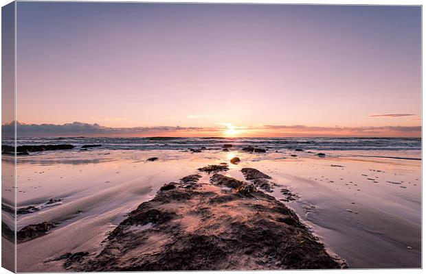  Sun setting on the Beach Canvas Print by Nick Rowland