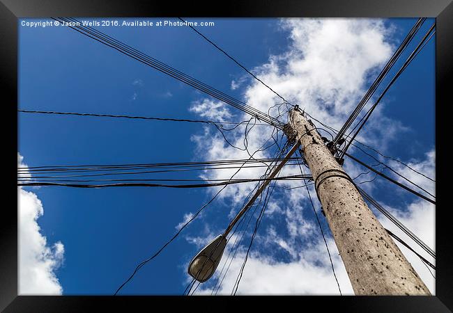 Looking up at a chaotic telegraph pole Framed Print by Jason Wells