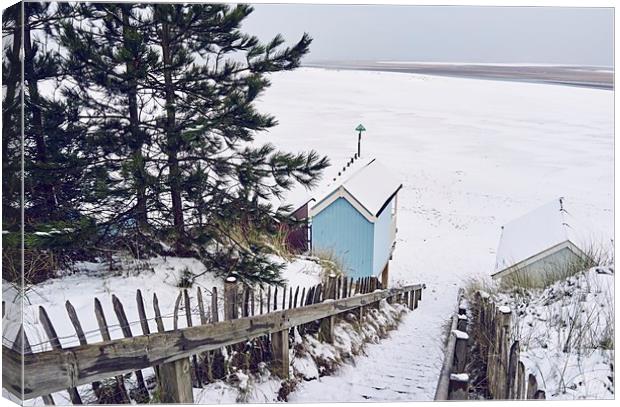 Steps and beach huts covered in snow. Wells-next-t Canvas Print by Liam Grant