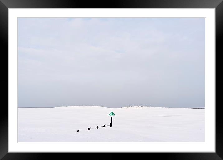 Groyne and beach covered in snow at low tide. Well Framed Mounted Print by Liam Grant