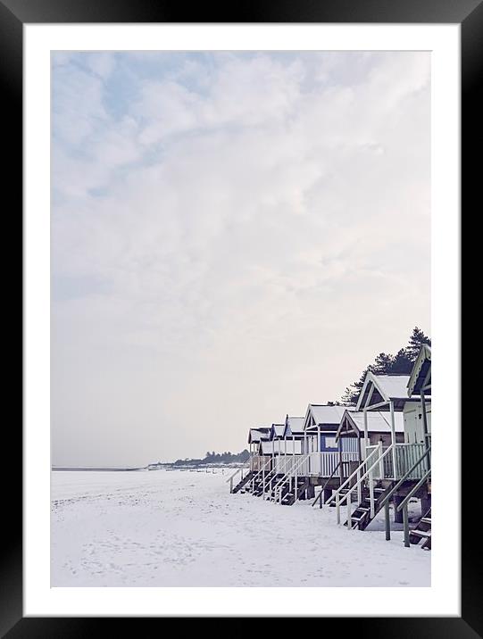 Beach huts covered in snow at low tide. Wells-next Framed Mounted Print by Liam Grant