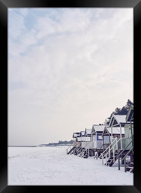 Beach huts covered in snow at low tide. Wells-next Framed Print by Liam Grant