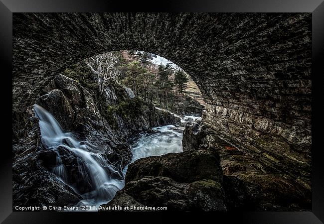 Waterfall View through a Bridge  Framed Print by Chris Evans