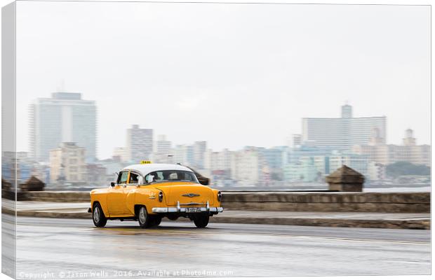 Yellow taxi hurtling down the Malecon Canvas Print by Jason Wells