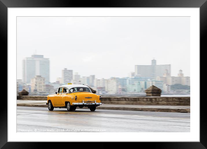 Yellow taxi hurtling down the Malecon Framed Mounted Print by Jason Wells