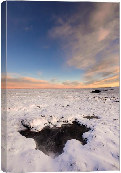 Icy pool on the snowy moors at dusk Canvas Print by Andrew Kearton