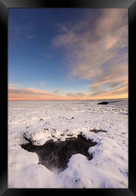 Icy pool on the snowy moors at dusk Framed Print by Andrew Kearton