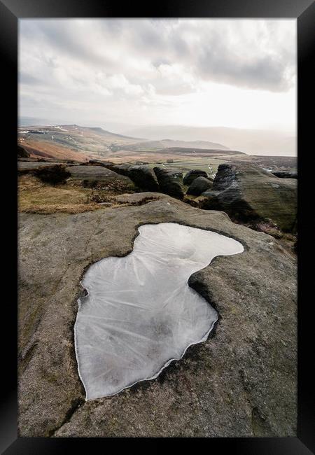 Frozen puddle on Stanage Edge at sunset. Derbyshir Framed Print by Liam Grant