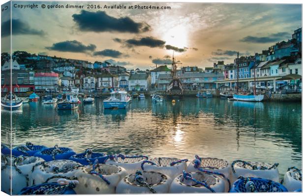 Brixham Harbour with a Setting Sun Canvas Print by Gordon Dimmer