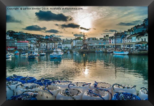 Brixham Harbour with a Setting Sun Framed Print by Gordon Dimmer