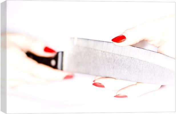 High-key female hand trying the sharpness of knife Canvas Print by Gabor Pozsgai