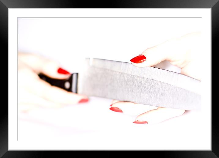 High-key female hand trying the sharpness of knife Framed Mounted Print by Gabor Pozsgai
