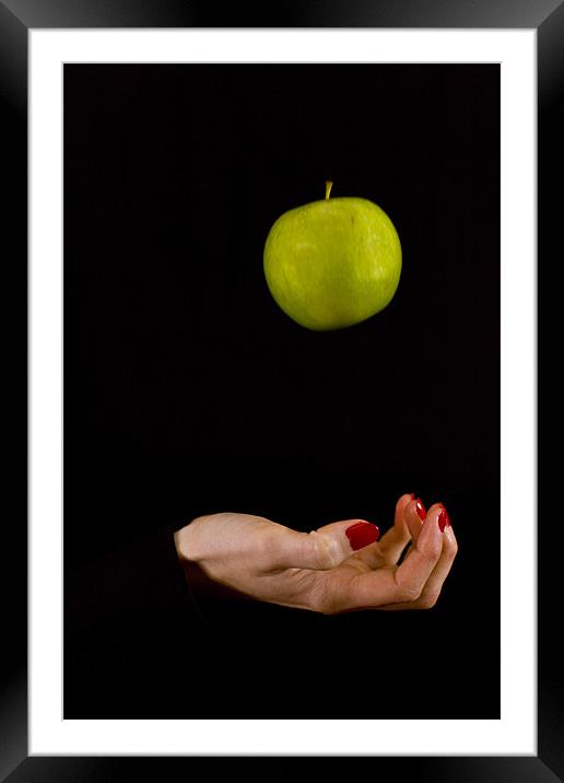 Female hand throwing a green apple Framed Mounted Print by Gabor Pozsgai