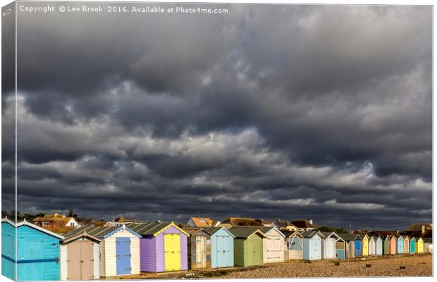 Ferring Beach Huts Under a Brooding Sky Canvas Print by Len Brook