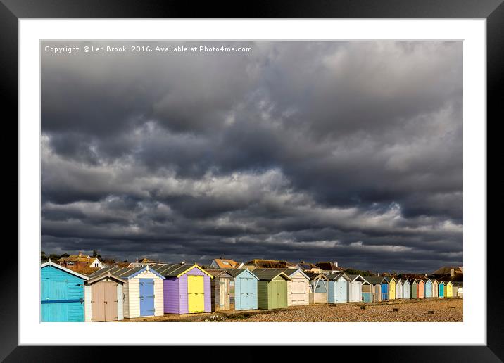 Ferring Beach Huts Under a Brooding Sky Framed Mounted Print by Len Brook