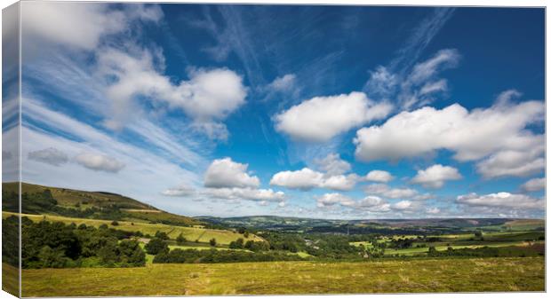 Fluffy clouds over Glossop Canvas Print by Andrew Kearton