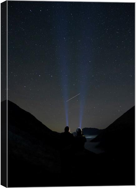 Young couple watching shooting stars in the mounta Canvas Print by Liam Grant