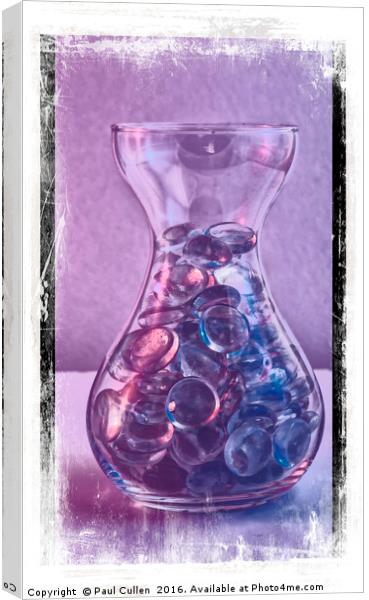 Jar of glass pebbles in hues of blue and purple. Canvas Print by Paul Cullen
