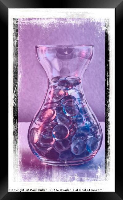 Jar of glass pebbles in hues of blue and purple. Framed Print by Paul Cullen