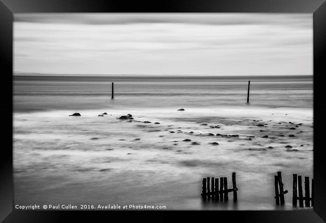 Wooden posts in the sea. Monochrome. Framed Print by Paul Cullen