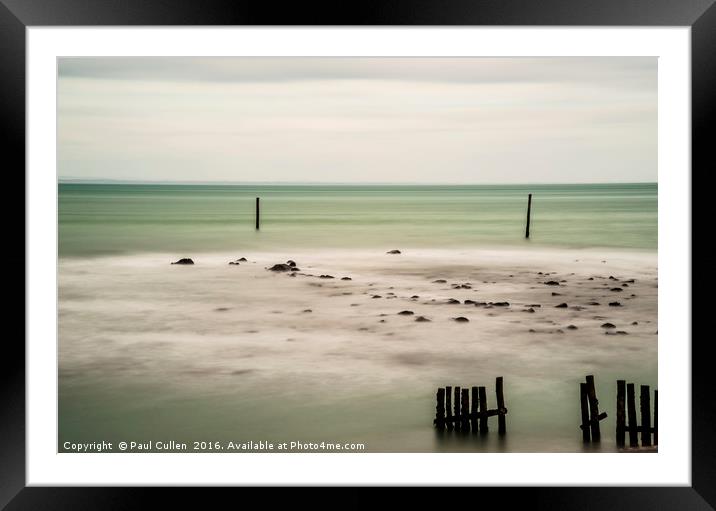 Wooden posts in the sea. Framed Mounted Print by Paul Cullen