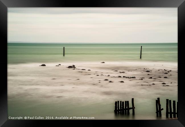 Wooden posts in the sea. Framed Print by Paul Cullen