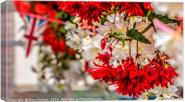 Red and white hanging flowers with a union jack in Canvas Print by Gary Norman