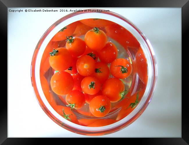 A bowl of baby tomatoes arranged in water. Framed Print by Elizabeth Debenham