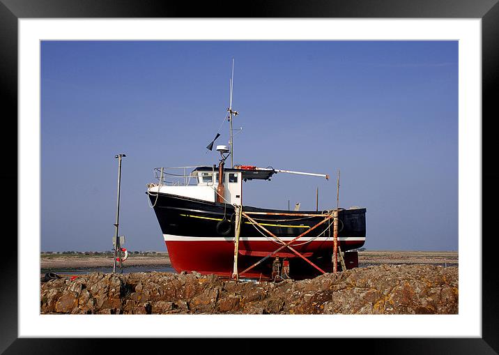 Red and black fishing boat on Lindisfarne Framed Mounted Print by Simon Marshall