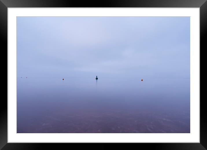 Cloudy sky a bouys reflected in a calm ocean at tw Framed Mounted Print by Liam Grant