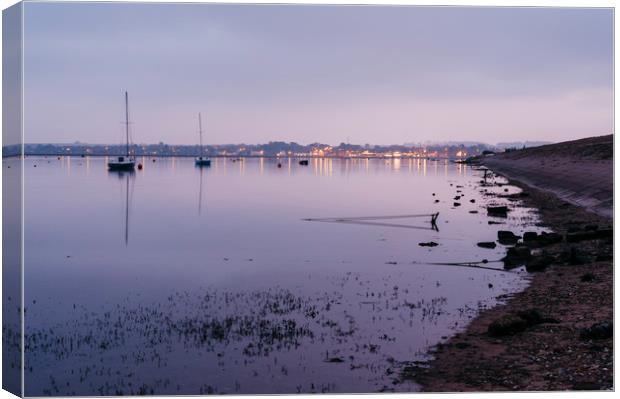 Boats and distant harbour reflected at twilight. W Canvas Print by Liam Grant