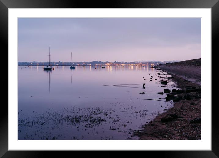 Boats and distant harbour reflected at twilight. W Framed Mounted Print by Liam Grant
