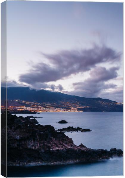 Volcanic coastline and lights of Santa Cruz at twi Canvas Print by Liam Grant