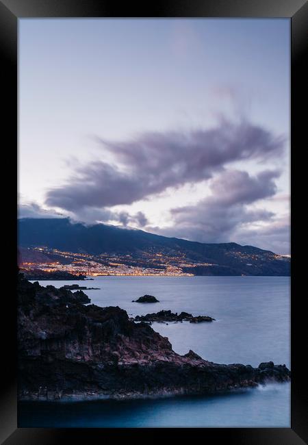 Volcanic coastline and lights of Santa Cruz at twi Framed Print by Liam Grant