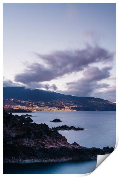 Volcanic coastline and lights of Santa Cruz at twi Print by Liam Grant