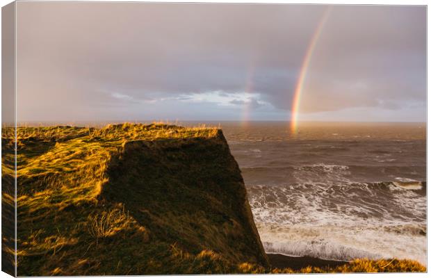 Rainbow and stormy sky at sunset. Sheringham, Norf Canvas Print by Liam Grant