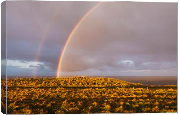 Rainbow and stormy sky at sunset. Sheringham, Norf Canvas Print by Liam Grant